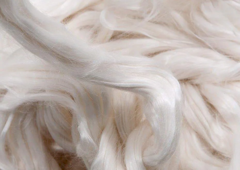 Cellulose crumbs are wet spun into soft, absorbent fibers, then washed and dried to remove chemicals