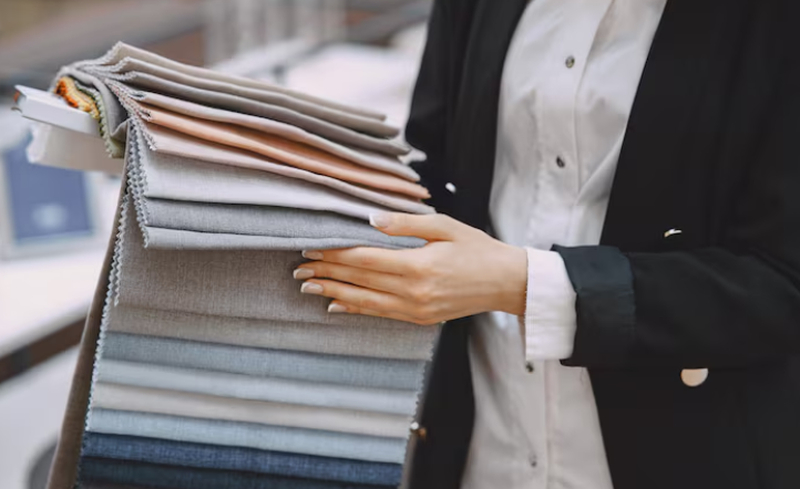 Common materials include cotton, polyester, and various blends, while fabric constructions such as jersey, interlock, or rib