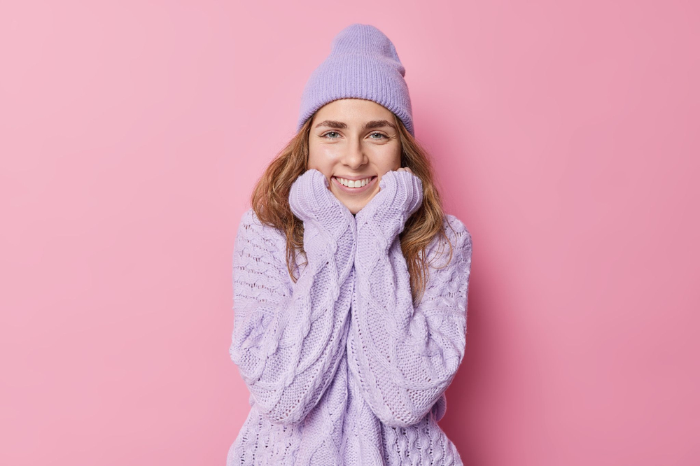 A sweater is a knitted garment designed to provide warmth and comfort, typically featuring long sleeves and made from materials such as wool, cotton, or synthetic fibers